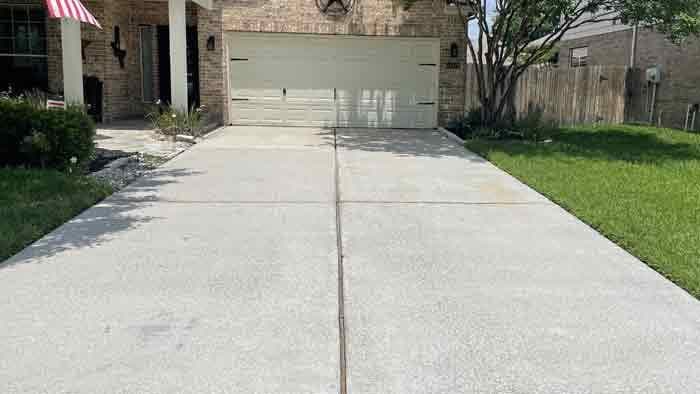 Clean, restored concrete driveway after pressure washing in Tomball, TX