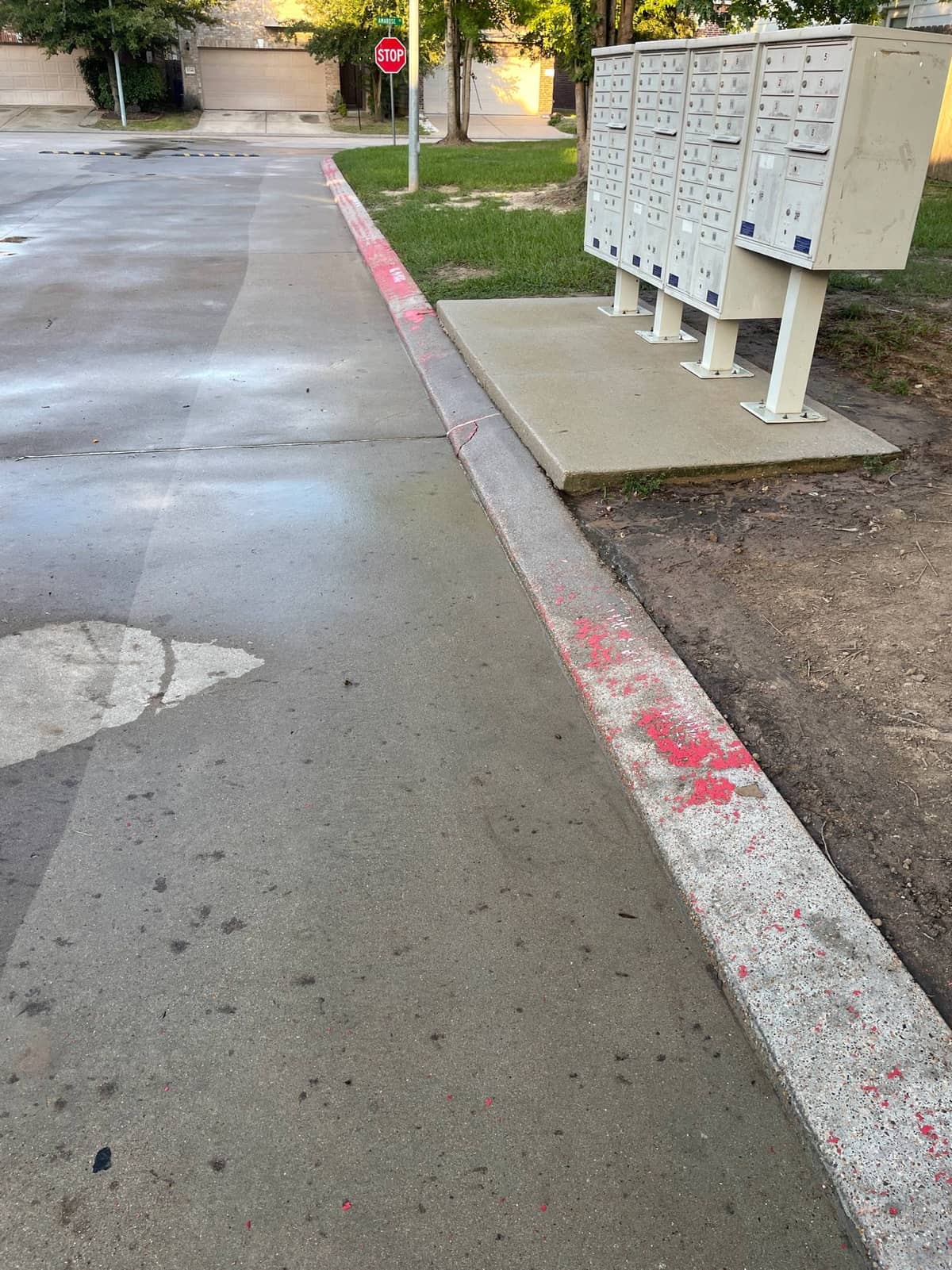 Freshly pressure washed curb ready for a new coat of paint at the HOA entrance