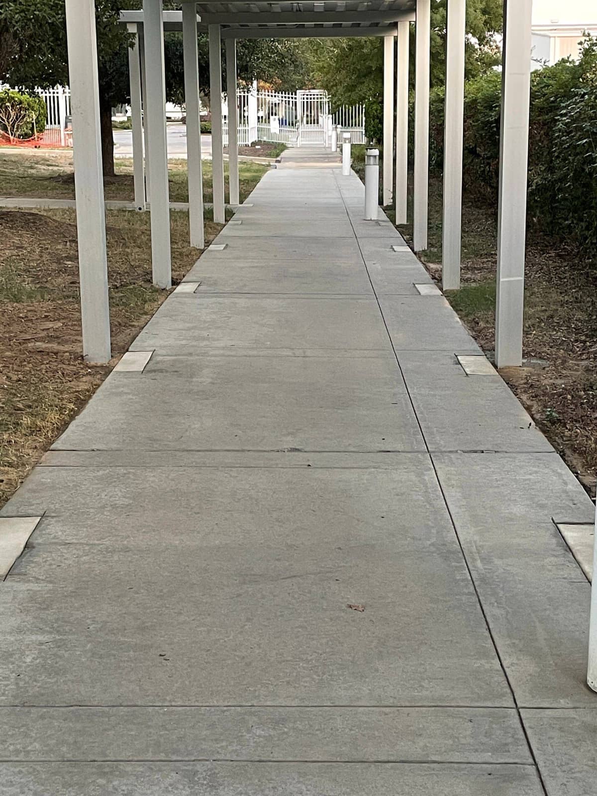 Post-construction dust and debris being pressure washed off a Tomball ISD building exterior