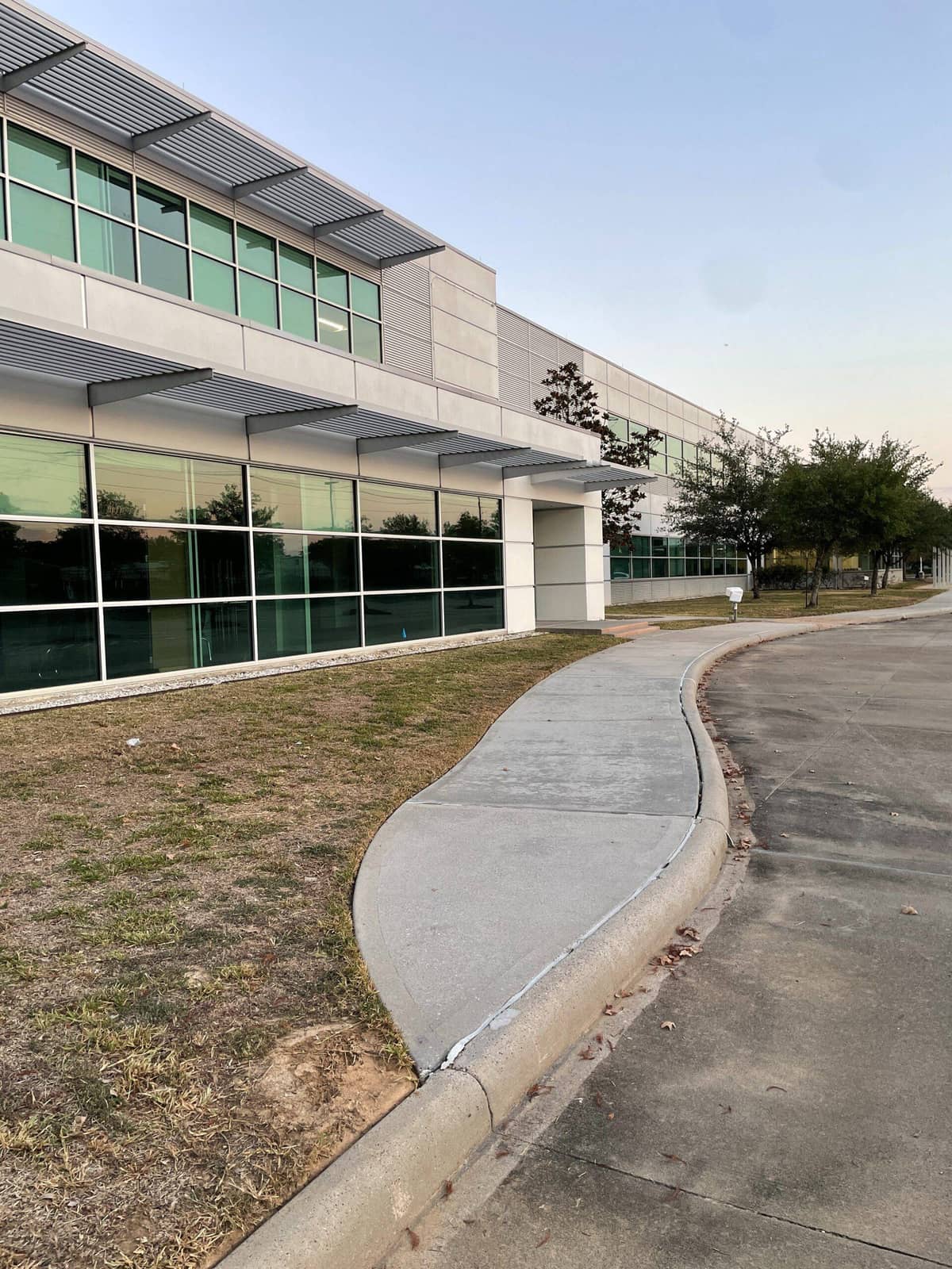 Crew pressure washing the entry walkway outside the Tomball ISD administrative building