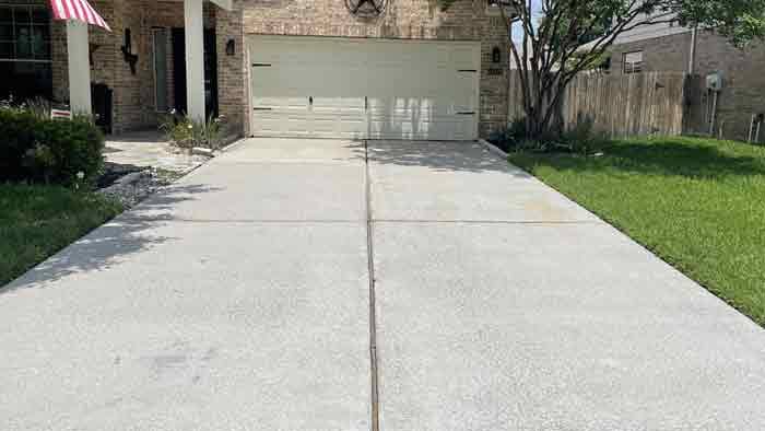 Driveway after pressure washing removed years of Crape Myrtle tree sap staining