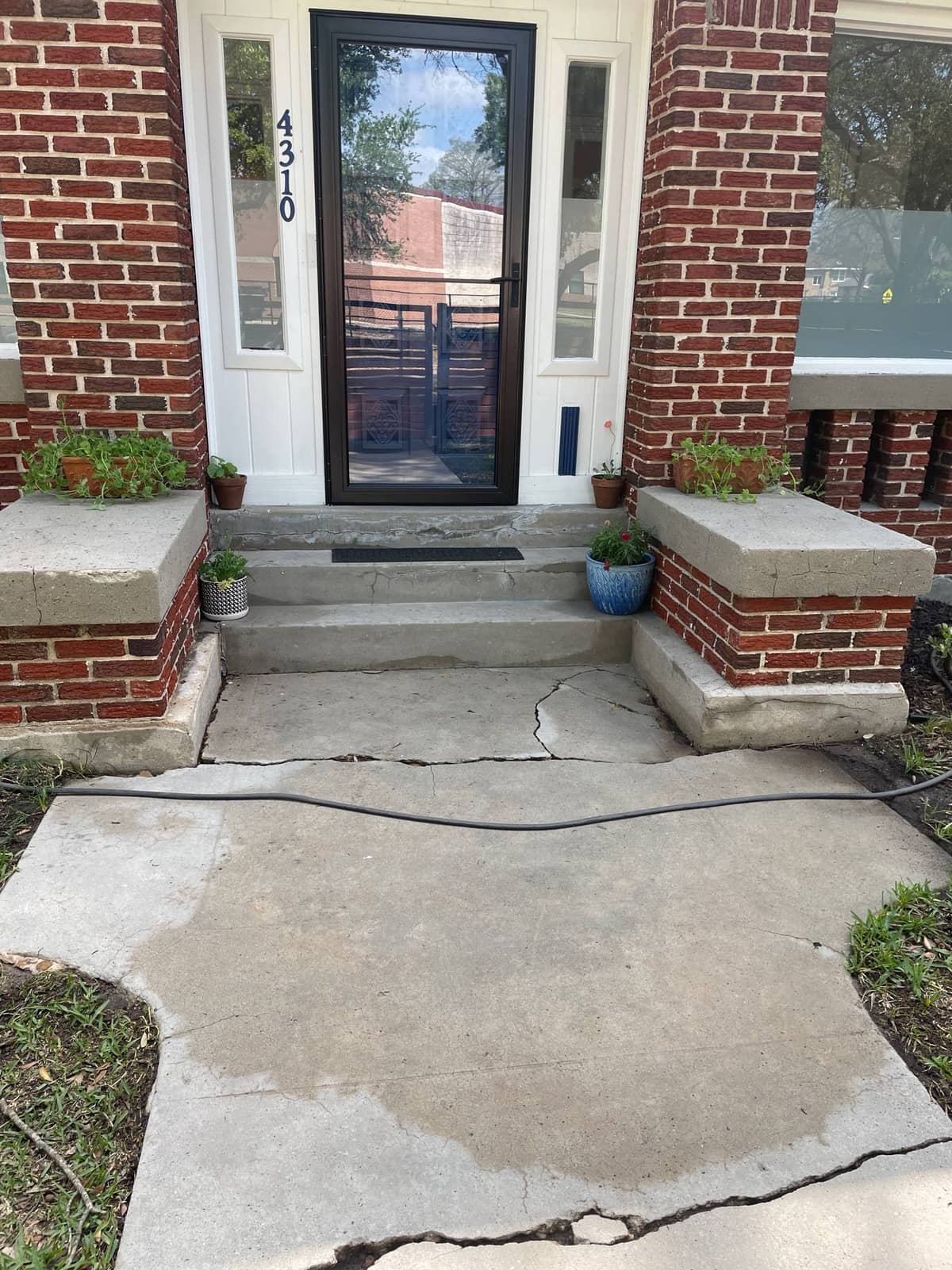 Exterior cleaning crew finishing up the back patio area of this Houston home