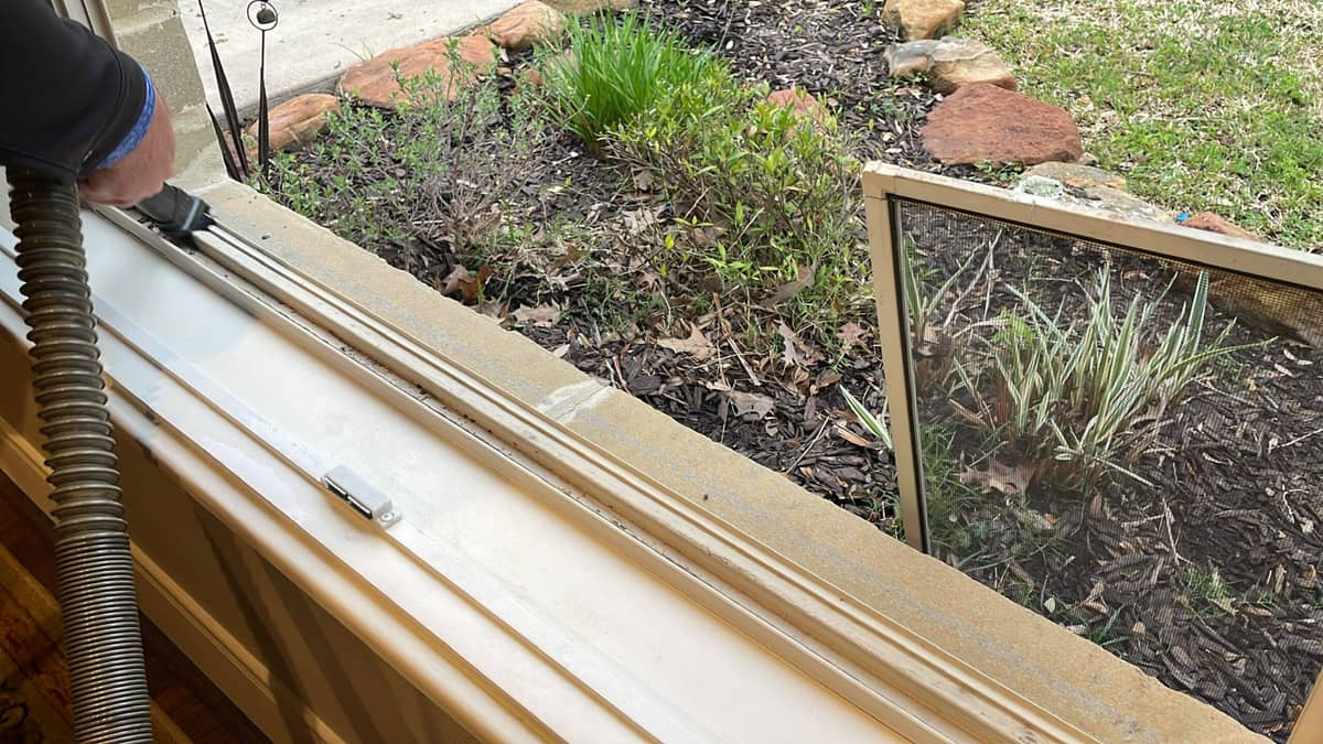 Soft washing crew cleaning siding on a Huntsville, TX home preparing to sell