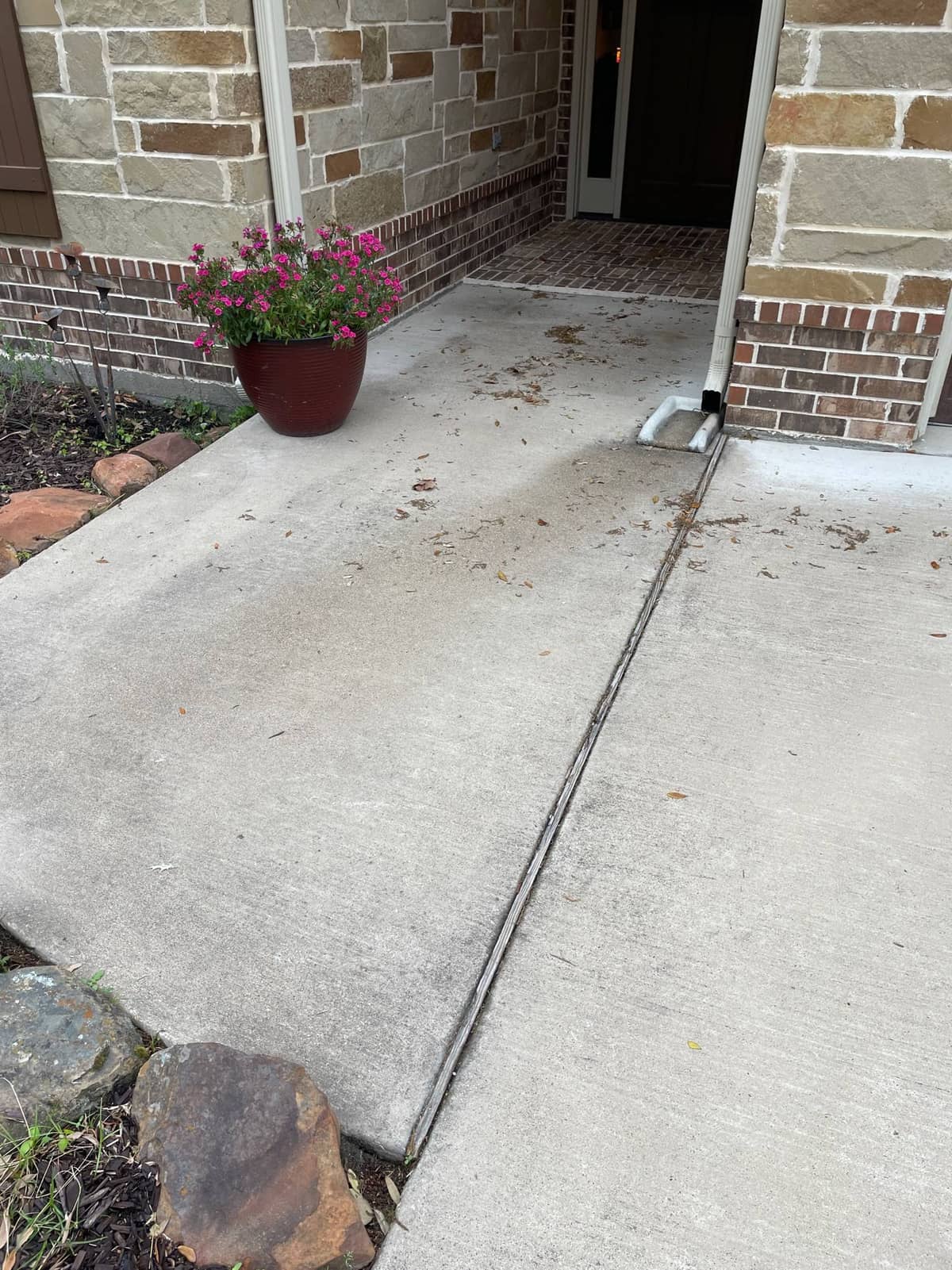 Driveway staining being treated during exterior cleaning in Huntsville, TX