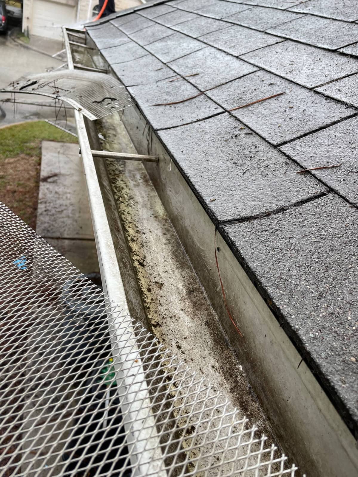 J Calvin service pro reinstalling gutter guards after cleaning in Spring, TX